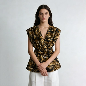 Detail of waist-tie design on sleeveless V-neck top with tiger print and metal buckle
