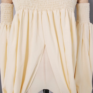 Close-up of beige off-shoulder top featuring smocked elastic waist and puff lantern sleeves