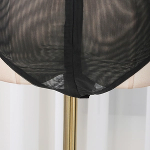 Detail shot of sheer black mesh bodysuit featuring high-cut design on a mannequin