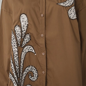 Close-up of brown casual shirt featuring intricate paisley sequin embroidery details