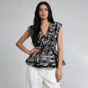 Detail of waist design with gold buckle and black white wave pattern on sleeveless top