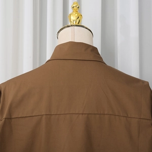 Close-up of the back stitching and collar detail on this brown casual cotton blend shirt