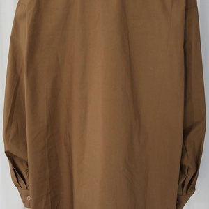 Close-up of the back and drop shoulder sleeve detail on a brown casual cotton shirt