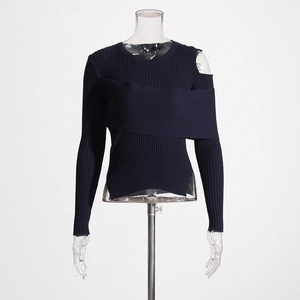 Detail of navy blue ribbed knit sweater with modern asymmetric shoulder cutout and layering