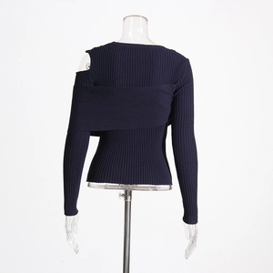 Detail of dark blue ribbed knit top showing asymmetric cutout shoulder and texture