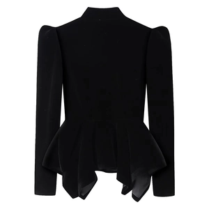 Detail of female black velvet long sleeve top with puff sleeves and peplum hem design