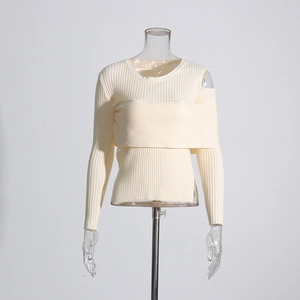 Close-up of cream off-shoulder knit sweater with ribbed texture and layering detail