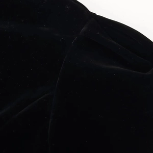 Close-up of black velvet fabric texture with soft pile finish and subtle sheen