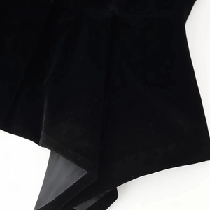 Detail of premium black velvet fabric texture and elegant stitching on the slim jacket