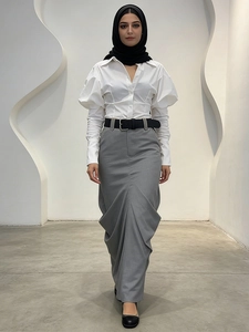 Muslim women's outfit with white puff sleeve shirt and grey pleated maxi skirt