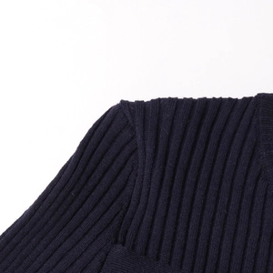 Detail of dark blue rib-knit shoulder seam showing high-quality fabric texture