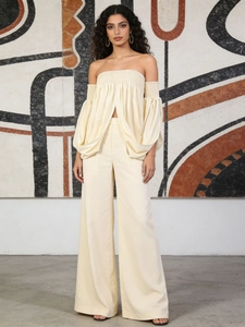 Elegant two-piece cream strapless top and high-waisted wide-leg trousers set