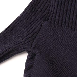 Detail of navy blue knitwear showing ribbed and flat-stitch textures with seamless joins