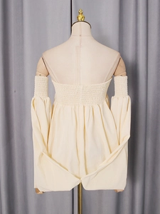 Back view of a chic off-shoulder cream blouse featuring elastic pleats and lantern sleeves