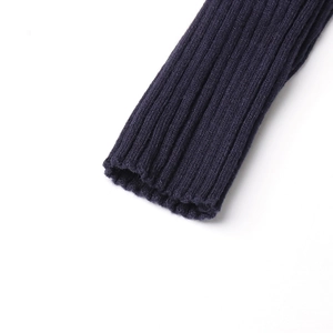 Detail view of the ribbed knit cuffs on a navy blue off-shoulder sweater for women