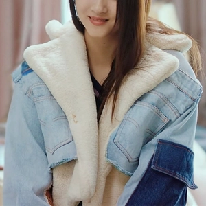 Close-up of contrast denim jacket showing plush faux shearling lining and large cargo pockets