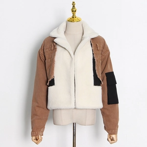 Detail of denim patchwork jacket with white faux shearling collar and cargo pocket