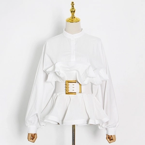 Detail of white ruffle blouse featuring a stand collar and wide belt with gold buckle