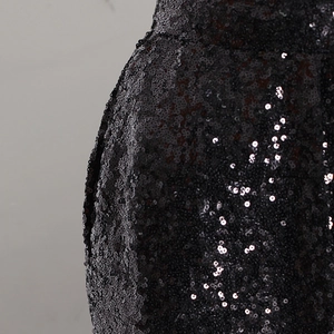 Vista dettagliata dei pantaloni a vita alta con dense paillettes nere e cuciture fini