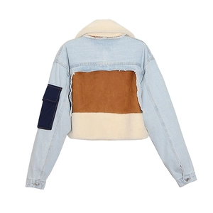 Detail of vintage denim jacket with brown suede and cream faux shearling back patchwork