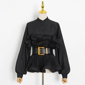 Detail of ruffled hem shirt with black leather belt and gold metallic square buckle