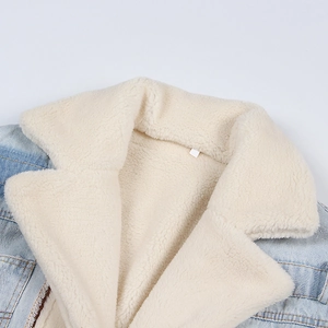 Detail view of denim jacket featuring thick faux shearling collar and soft inner lining