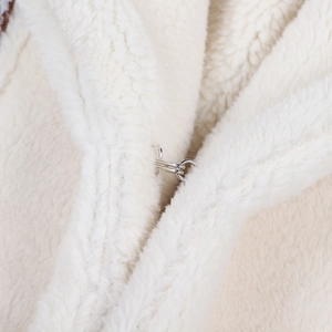 Detail of silver hook-and-eye closure on white thick plush fleece jacket collar