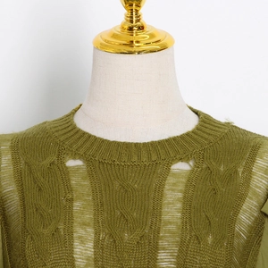 Close-up of moss green cable knit sweater with distressed cut-outs and rib neck details