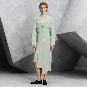 Detail view of sage green trench dress with side waist cut-outs and asymmetric hemline