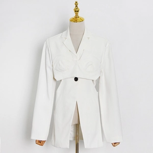 Detail of white fashion blazer with cutout waist design and structured cups