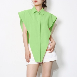 Detail of light green sleeveless shirt featuring asymmetrical geometric hem and collar