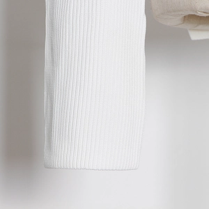 Close-up of white ribbed knit fabric texture with high quality elastic stitching details