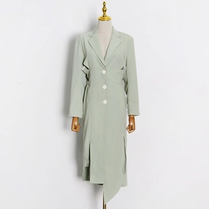 Detail of light green coat with side waist cut-outs and asymmetric irregular hemline