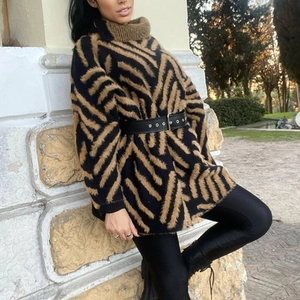 Detail of loose-fit women's striped knit sweater featuring ribbed collar and mink fur texture