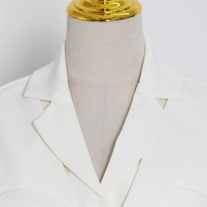 Detail of white blazer lapel showing high-quality stitching and structured shoulder design