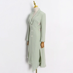 Detail of mint green trench coat featuring waist hollow-out design and side split hem