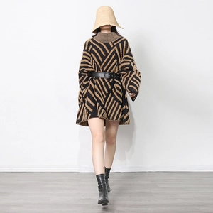 Full view of women's loose mink-like knitted sweater with dark coffee geometric stripes