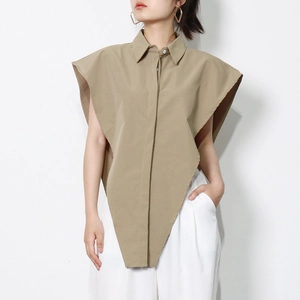 Detail of khaki sleeveless lapel shirt featuring a unique asymmetric triangular hemline