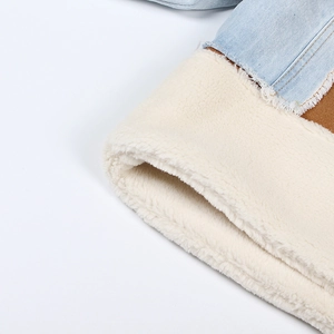 Detailed macro view of denim and brown suede jacket with thick white fleece lining