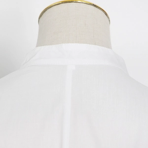 Detailed view of white stand collar and premium stitching on women's long sleeve shirt