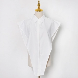 Detail of white shirt collar accessory with button-down front and irregular triangle hem