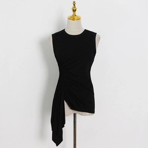 Detail of black slim fit top with ruched waist and asymmetric ruffled hem design