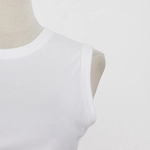 Detailed close-up of white crew neck sleeveless top with reinforced double stitching