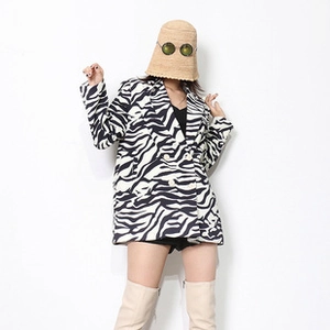 Detail view of stylish zebra print double-breasted blazer with classic black and white patterns