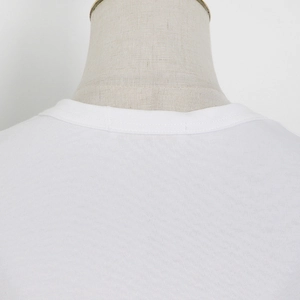 Detail of white cotton slim T-shirt with fine knitted texture and round neckline