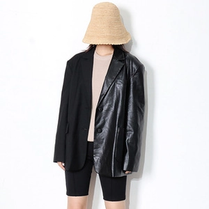Detailed front view of oversized spliced blazer with leather and twill fabric texture