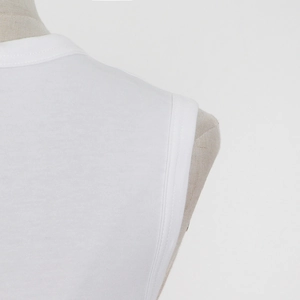 Detailed close-up showing the neat stitching and soft fabric texture on a white tank top