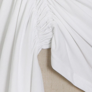 Detail of ruched stitching and fabric texture on a white slim-fit short sleeve top