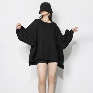 Detail of black oversized crewneck sweatshirt with dropped shoulders and ribbed cuffs