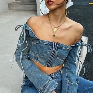 Blue washed denim off-shoulder crop top with lace-up sleeves and front zipper closure